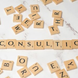 Scrabble tiles spelling 'Consulting' on a stylish marble surface symbolize strategic creativity.
